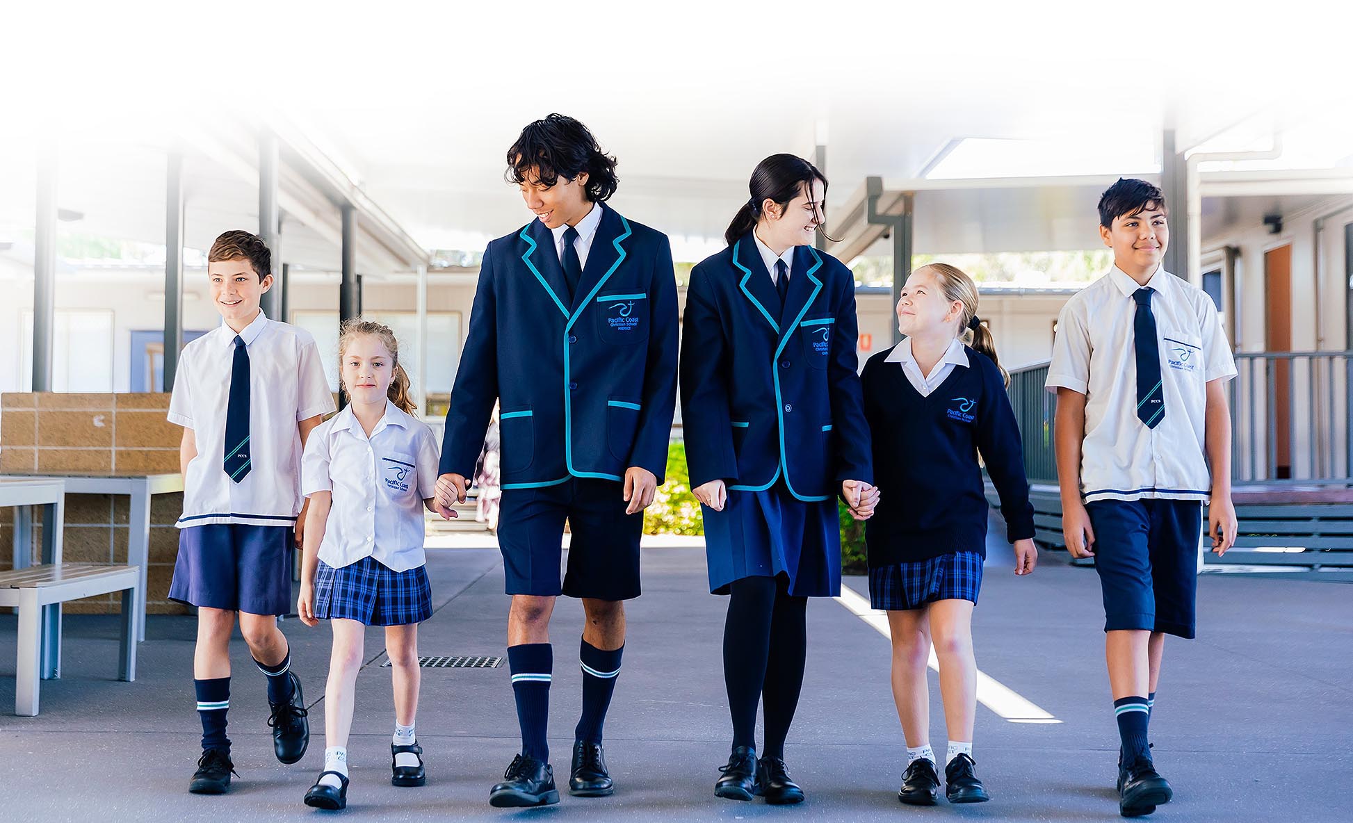 Group of Pacific Coast students walking through the school