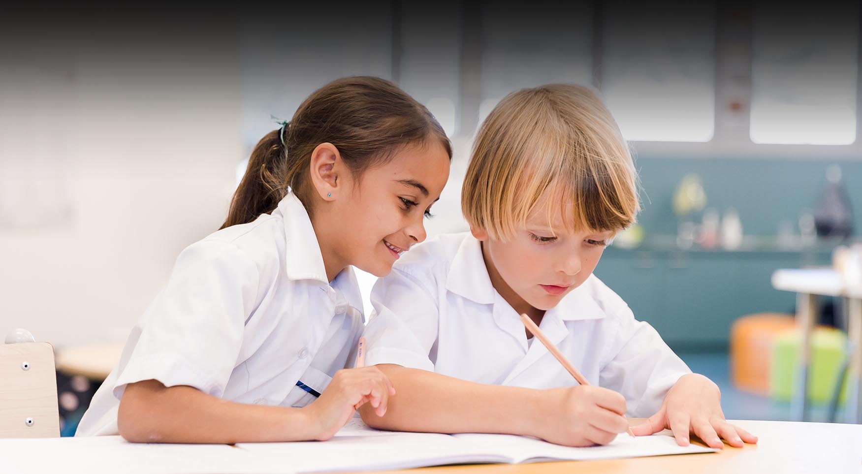 Pacific Coast students writing in a notebook